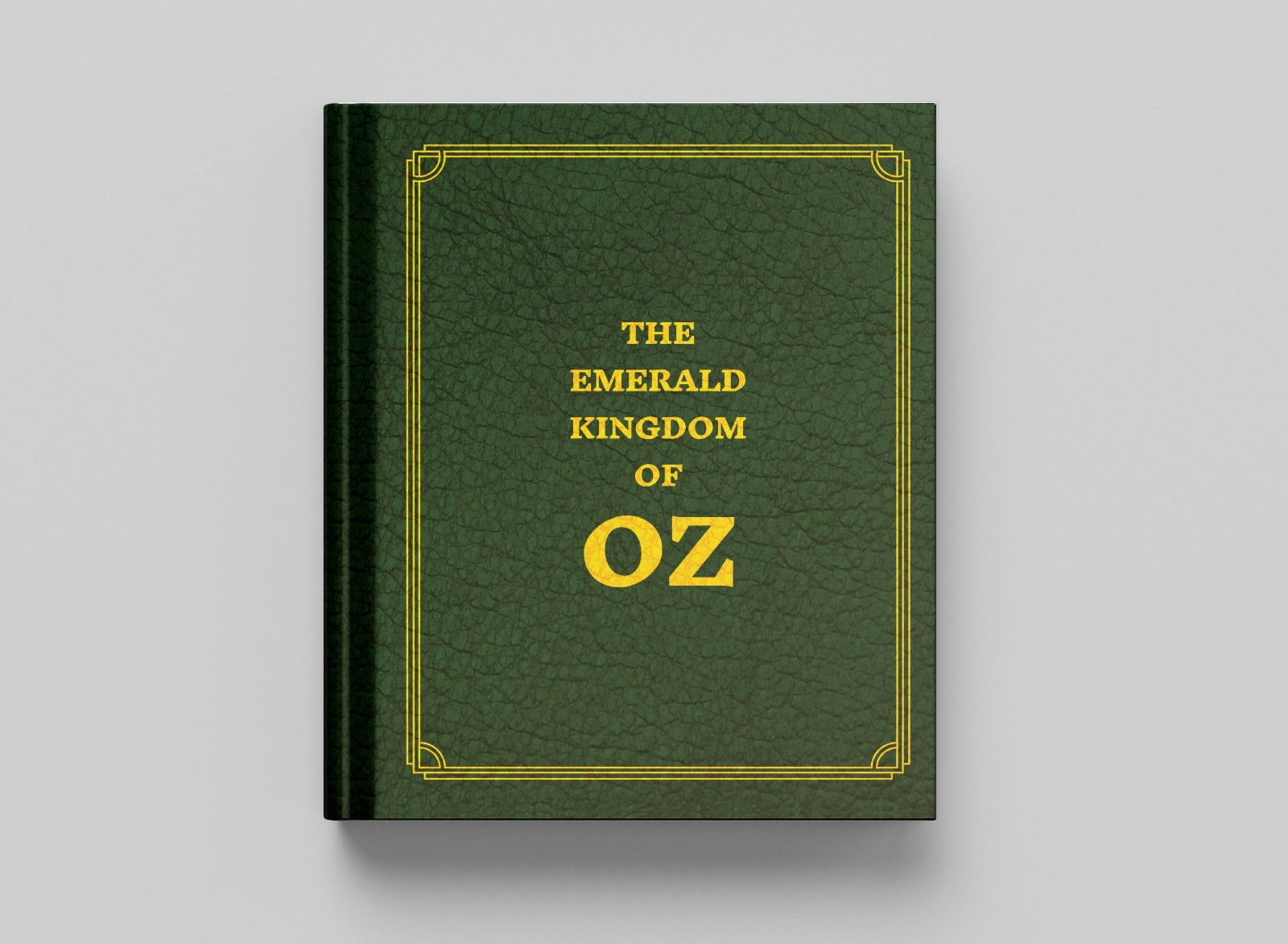 A top-down image of a mockup of The Emerald Kingdom of Oz, an rpg sourcebook. It is bound in green leather with gold lettering displaying the title.